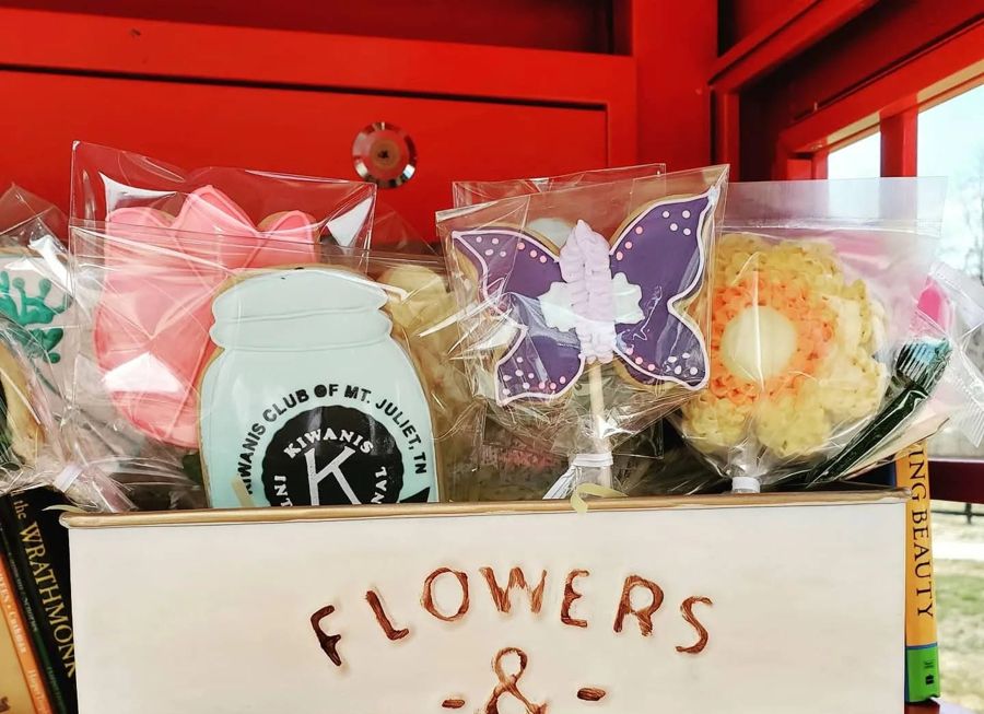 Flower and garden cookies on sticks, including a Kiwanis Club of Mt. Juliet logo cookie