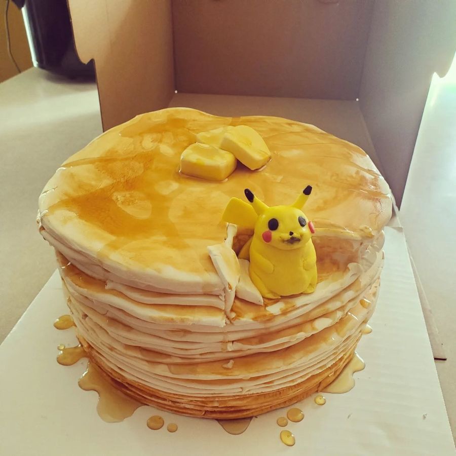 Pancake stack cake with syrup, butter and a Pikachu figure