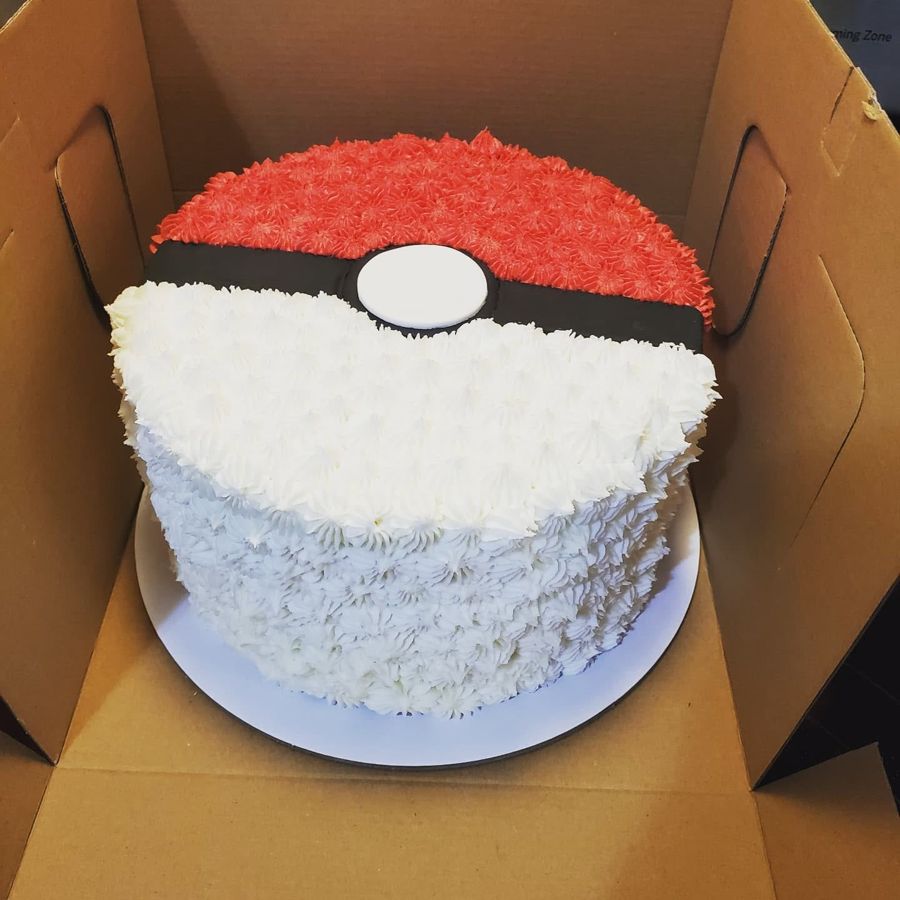 Red and white buttercream Poke Ball cake