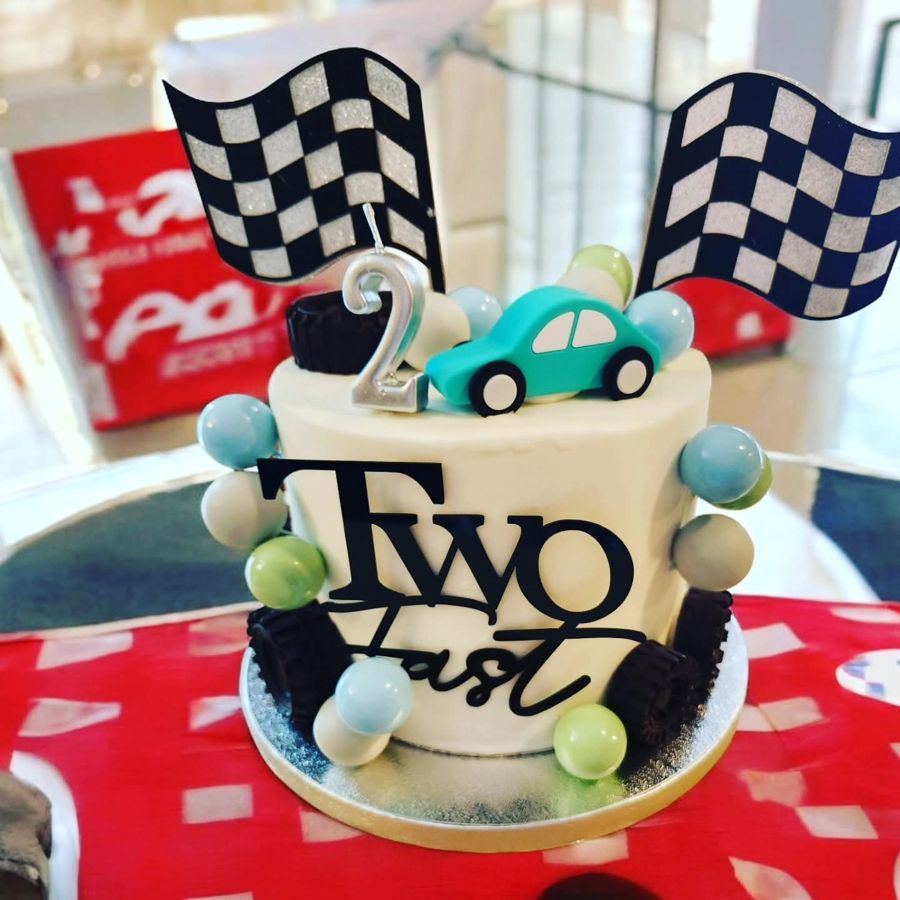 Two Fast race car cake for a 2nd birthday with checkered flags